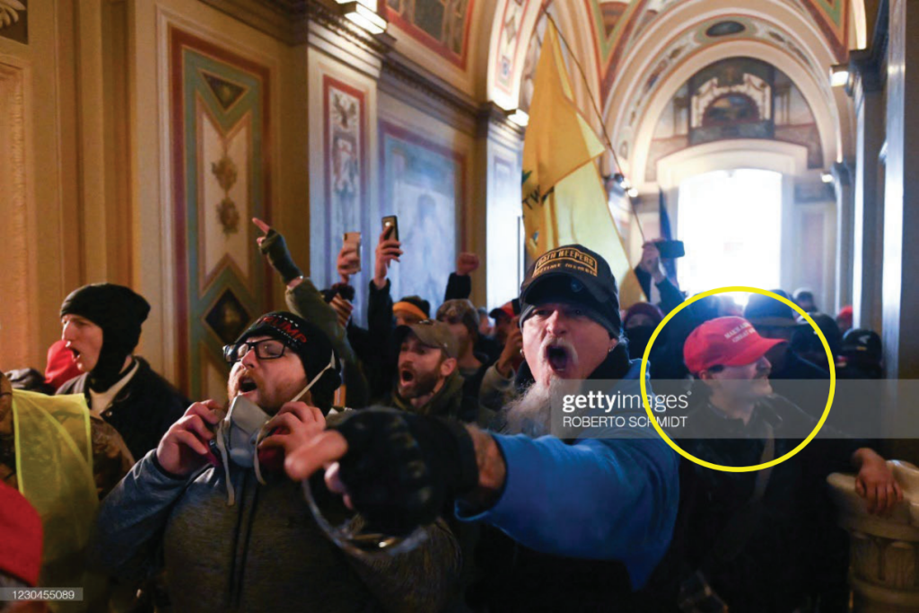 A group of men yell and march into the capitol